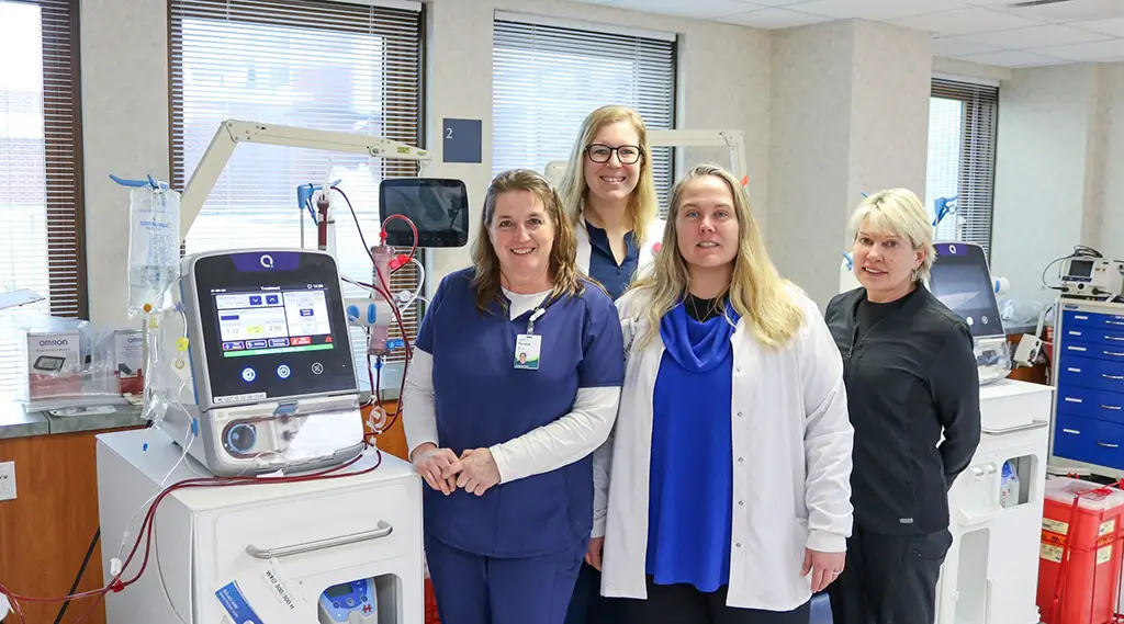 Medical staff posing next to a Quanta Dialysis system